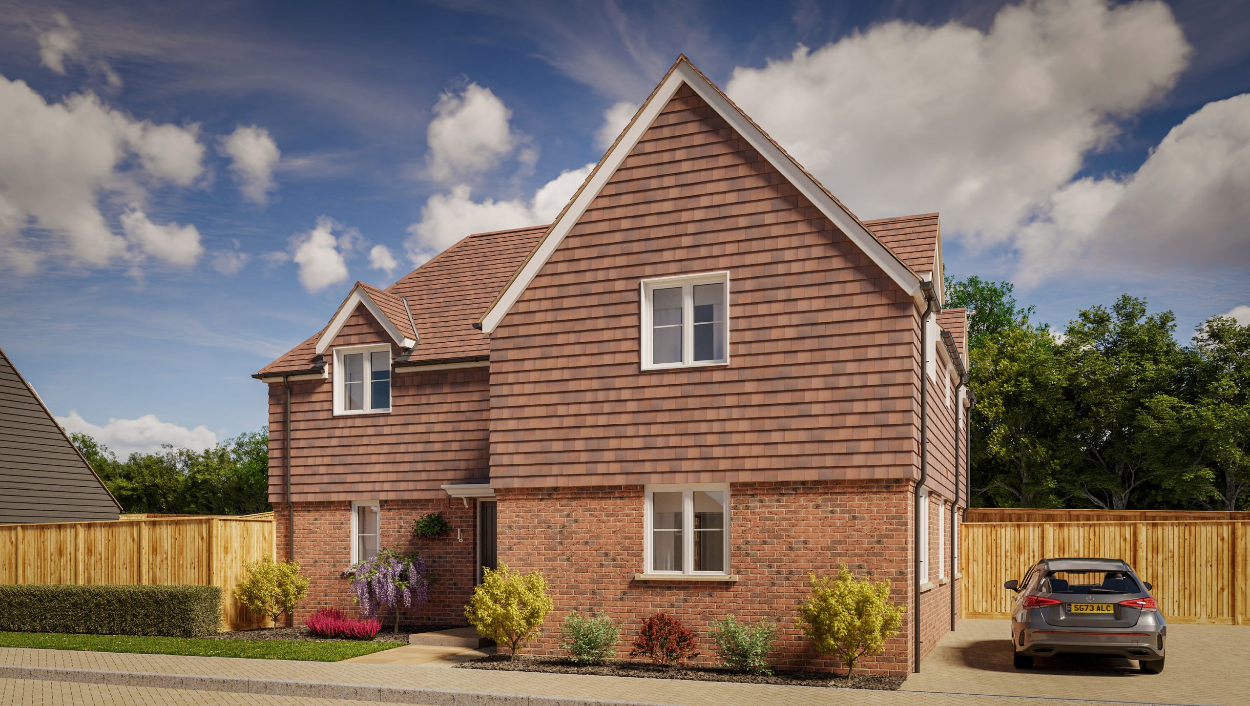 A large two-story brick house with a landscaped front garden and parked car on the front drive