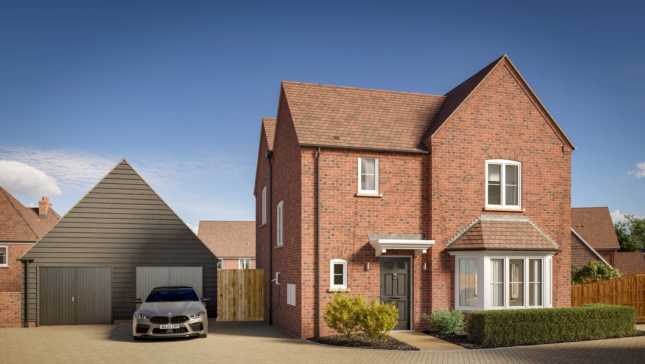 A large modern brick house with a detached garage and a car parked outside under a clear blue sky.