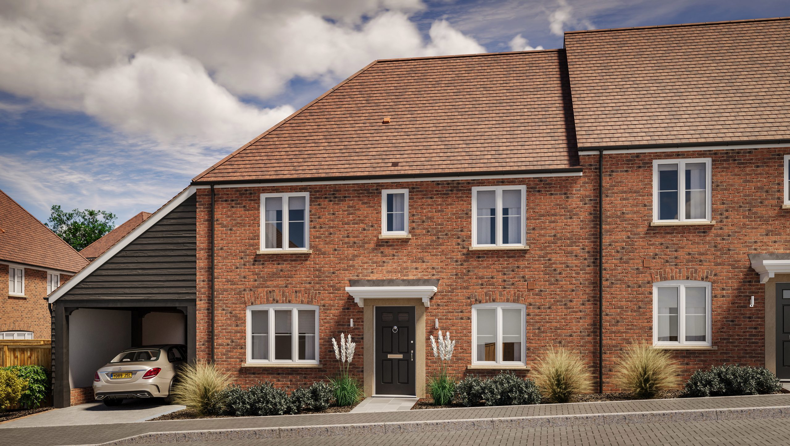 New semi-detached brick house with a car parked under an attached carport, under a cloudy sky.