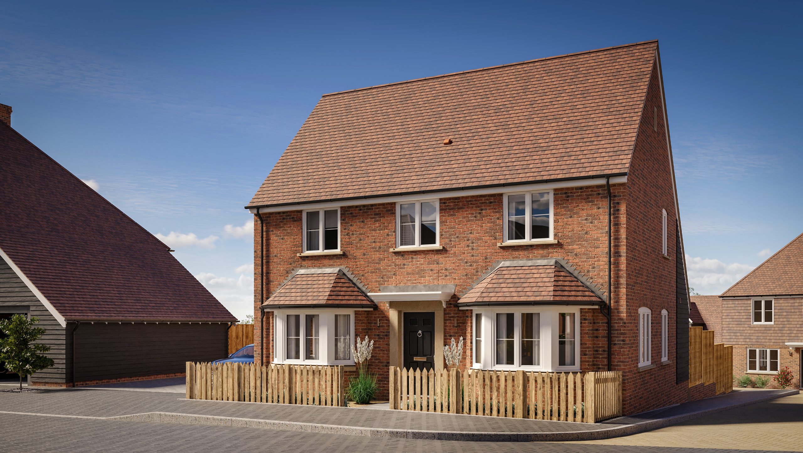 New two-story brick house with a wooden face enclosing the front garden and a brick road that leads down the right hand side to another property.
